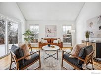 Cozy living room featuring modern furniture, bright windows, and stylish decor at 910 Homer Cir, Lafayette, CO 80026