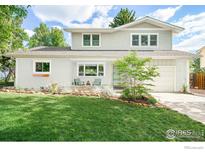 Charming two-story home with a well-manicured lawn, painted brick, and inviting front porch at 1635 Quince Ave, Boulder, CO 80304