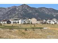 Scenic view of neighborhood homes in front of a mountain range on a clear day at 18673 W 94Th Ln, Arvada, CO 80007