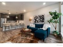 Comfortable living room features a blue sofa, modern art, and a well-lit open space at 20 Wilcox St # 519, Castle Rock, CO 80104