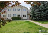 Inviting home with a well-maintained lawn, mature trees, and a classic facade, perfect for comfortable living at 2143 Meadow Ct, Longmont, CO 80501