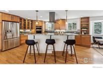 Modern kitchen boasts stainless steel appliances, granite countertops, and a stylish island with bar seating at 3115 Heidelberg Dr, Boulder, CO 80305