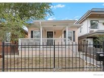 Charming home featuring a cozy front porch and a well-maintained yard enclosed by a classic black metal fence at 3244 Vallejo St, Denver, CO 80211