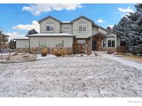 Charming two-story home with stone accents and a snow-covered front yard at 4012 Milano Ln, Longmont, CO 80503