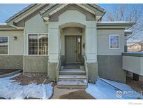 Inviting front door with a covered entryway and steps leading up to the entrance at 4143 Da Vinci Dr, Longmont, CO 80503