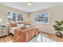 Bright bedroom with hardwood floors, large windows, and stylish furniture at 4760 Mckinley Dr, Boulder, CO 80303