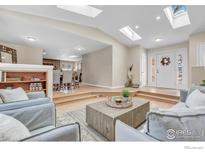 Bright living room featuring hardwood floors, skylights, and an open-concept layout perfect for entertaining at 4760 Mckinley Dr, Boulder, CO 80303