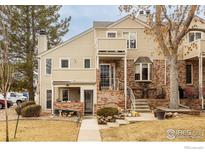 Charming townhouse featuring a blend of brick and siding, complemented by a well-manicured front yard and inviting entrance at 5001 Garrison St # 6, Wheat Ridge, CO 80033