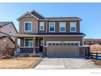 Charming two-story home featuring a two-car garage and well-maintained front yard at 9685 Bellaire Ln, Thornton, CO 80229