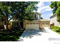 Charming two-story home with mature trees, a spacious driveway, and a two-car garage at 9757 Kipling St, Broomfield, CO 80021