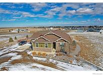 Charming ranch-style home with stone accents, mature landscaping, and a spacious driveway with surrounding community at 16504 N Fairbanks N Rd, Platteville, CO 80651