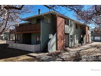 Inviting two-story exterior with a brick chimney and private patio at 1905 Chalcis Dr # A, Lafayette, CO 80026