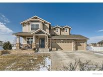 Charming two-story home featuring a welcoming front porch and three-car garage at 2289 French Cir, Longmont, CO 80504