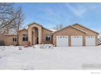 Charming brick home with a three-car garage and snow-covered front yard at 232 Elizabeth Ct, Fort Lupton, CO 80621