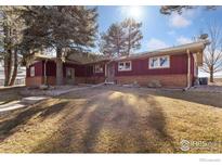 Charming single-story home with a covered porch and a well-maintained front yard at 3401 Meining Rd, Berthoud, CO 80513