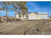 Charming ranch-style house with a long driveway and attached garage, plus a separate large garage out back at 4700 Karen Ct, Berthoud, CO 80513