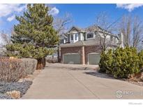 Two-story home featuring a two car garage, brick accents and mature landscaping at 5656 Cascade Pl, Boulder, CO 80303