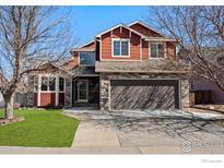 Charming two-story home with red siding and stone accents at 602 S 34Th Ave, Brighton, CO 80601