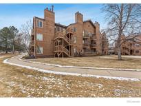 Multi-level condo building shows wood siding, open stairways, and balconies at 6118 Habitat Dr # 1, Boulder, CO 80301