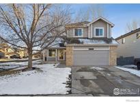 Charming two-story home with a two-car garage and beautifully maintained front yard at 6924 Quigley Cir, Firestone, CO 80504