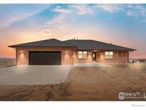 Charming brick home featuring an attached two-car garage, well-maintained landscaping, and a welcoming entrance at 11837 County Road 39, Fort Lupton, CO 80621