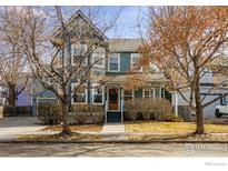Charming two-story home boasts a quaint front porch and mature landscaping at 1239 Tyler Pl, Erie, CO 80516