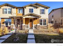 Charming two-story home with inviting front porch and well-maintained landscaping at 13725 Ash Cir, Thornton, CO 80602