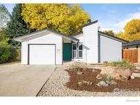 Charming single-story home with a well-maintained front yard featuring a rock garden and an attached garage at 1513 Atwood St, Longmont, CO 80501