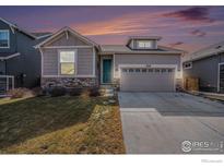 Charming single-Gathering home with stone accents, inviting curb appeal, and two car garage at 479 Grand Market Ave, Berthoud, CO 80513