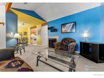 Inviting living area featuring bright accent walls, a cozy fireplace, and stylish glass coffee table at 5520 Stonewall Pl # 31, Boulder, CO 80303
