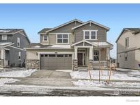 Charming two-story home with a well-maintained front yard and attractive curb appeal during winter at 189 Baler Ct, Brighton, CO 80601