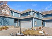 Charming blue two-story home with attached garage and stone accents, perfect for comfortable living at 281 Rockview Dr, Superior, CO 80027