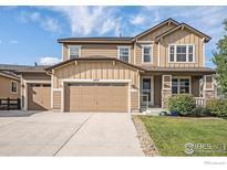 Charming two-story home with a three-car garage and well-maintained lawn at 4679 Lakeside Dr, Longmont, CO 80504