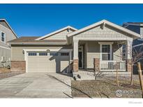 Charming single-Gathering home featuring a two-car garage and covered front porch at 4847 Astor Pl, Brighton, CO 80601