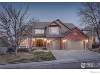 Charming two-story brick home featuring a three-car garage and mature landscaping at 630 S Snowmass Cir, Superior, CO 80027
