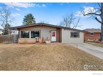 Charming ranch-style home featuring a well-manicured lawn and inviting front entrance at 840 10Th St, Berthoud, CO 80513