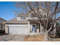Charming two-story home featuring a well-maintained front yard, garage, and inviting entrance at 11499 Kenton St, Commerce City, CO 80640