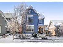 Beautiful two-story home with blue siding and snow-covered yard at 1526 Haystack Way, Lafayette, CO 80026