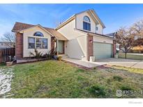 Charming two-story home with a well-maintained lawn and inviting curb appeal at 1749 Foster Dr, Longmont, CO 80501