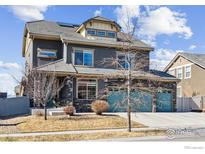 Beautiful two-story home with three-car garage and well-kept lawn at 244 Pipit Lake Way, Erie, CO 80516