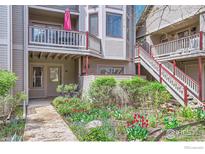 Charming condo with a cozy balcony, lush garden, and colorful flowers at 275 Pearl St # 11, Boulder, CO 80302