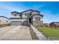 Charming two-story home with stone accents and a well-manicured front yard at 55 Morgan S Cir, Erie, CO 80516