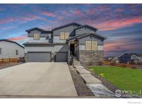 Beautiful two-story home with stone accents, manicured lawn, and a spacious two-car garage at 55 Morgan S Cir, Erie, CO 80516