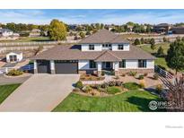 Stunning two-story home with manicured lawn and three-car garage in a beautiful neighborhood at 6006 E 162Nd Pl, Brighton, CO 80602