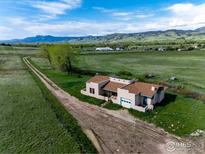 Stunning exterior elevation of a home with a private drive and mountain views at 8602 N 39Th St, Longmont, CO 80503