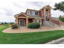 Charming home with a well-manicured lawn and inviting front entrance, showcasing curb appeal at 13722 Legend Way # 101, Broomfield, CO 80023