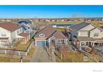 Charming single Gathering home with mature landscaping, cozy porch, and water views in a desirable neighborhood at 1392 S Duquesne Cir, Aurora, CO 80018