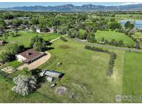 Expansive property featuring lush green pastures and mountain views, ideal for outdoor living at 1866 Park Lake Dr, Boulder, CO 80301