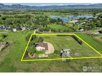Idyllic farm property with scenic mountain views, surrounded by lush greenery and a tranquil lake at 1866 Park Lake Dr, Boulder, CO 80301