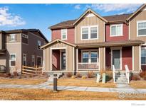 Charming townhome with colorful exterior and inviting front porch at 2342 Irons St, Erie, CO 80516